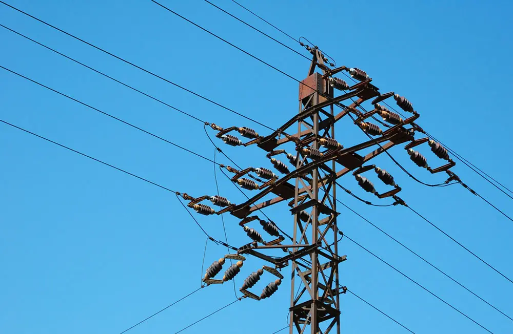 Health and safety in the construction and maintenance industry as a workman is seen from below in a cherry picker by a utility pole